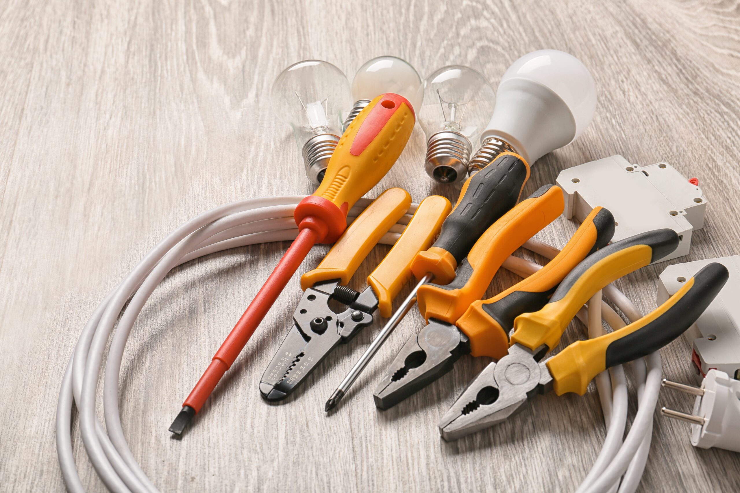Different Electrician's Supplies On Wooden Floor